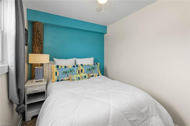 bedroom with hardwood / wood-style floors and ceiling fan