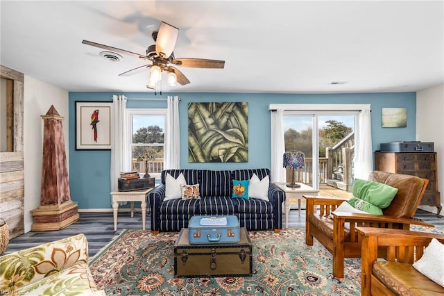 living room featuring ceiling fan, hardwood / wood-style floors, and a healthy amount of sunlight