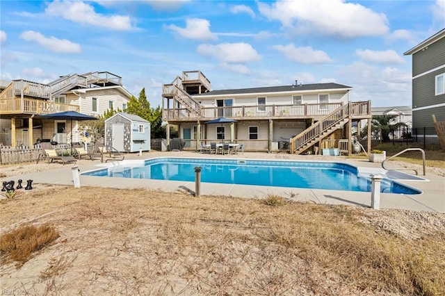 view of pool featuring a wooden deck and a patio area