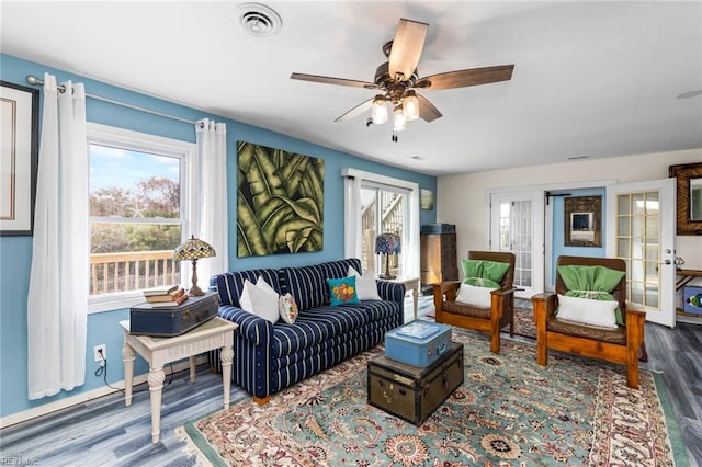 living room featuring hardwood / wood-style floors, ceiling fan, and french doors