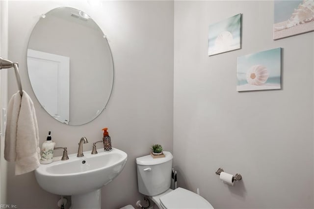 bathroom featuring toilet and sink