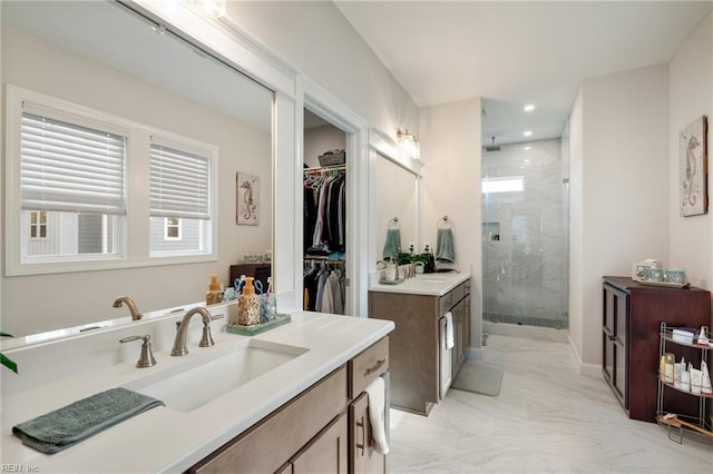 bathroom with a shower with door and vanity