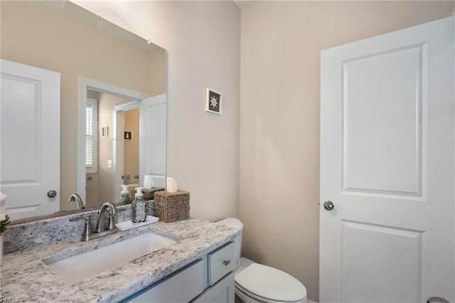 bathroom with toilet and vanity