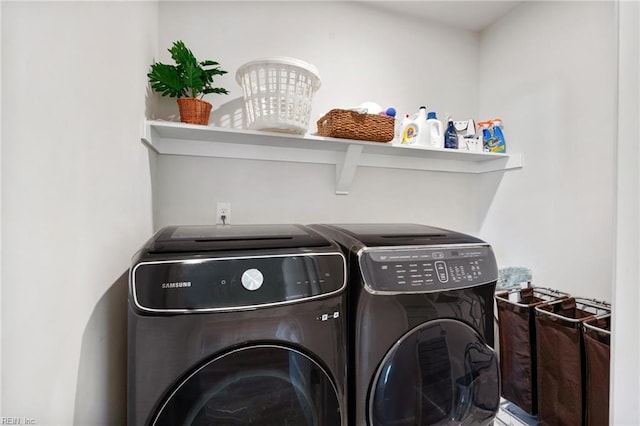 clothes washing area with washer and clothes dryer