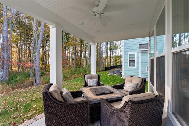 view of patio / terrace featuring ceiling fan and an outdoor fire pit