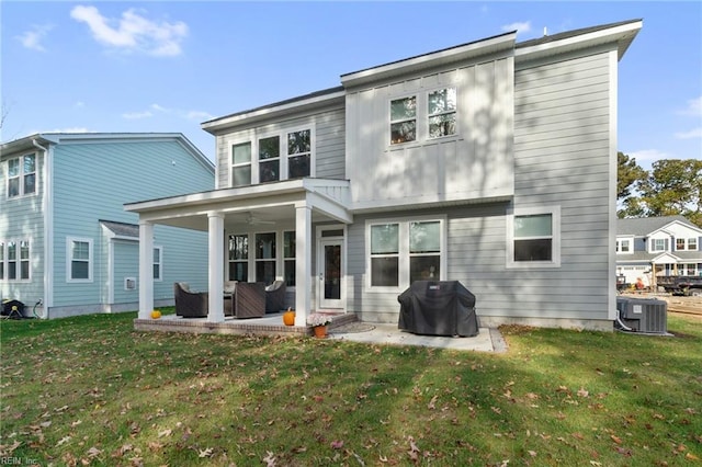 rear view of house with a patio area, a yard, and central air condition unit