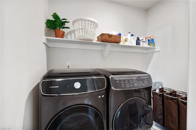 clothes washing area featuring washing machine and clothes dryer