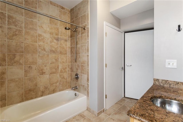 bathroom featuring vanity and tiled shower / bath combo