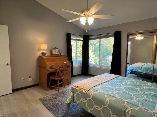 bedroom with light hardwood / wood-style floors, lofted ceiling, ceiling fan, and a closet