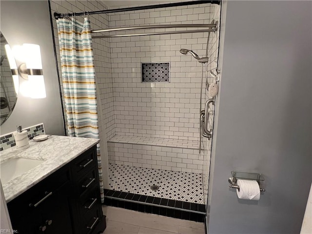 bathroom with walk in shower and vanity