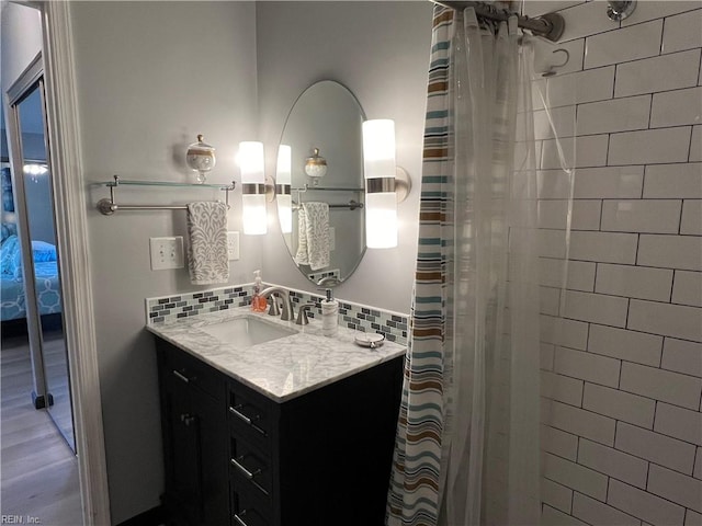 bathroom with tile walls, vanity, hardwood / wood-style flooring, and walk in shower