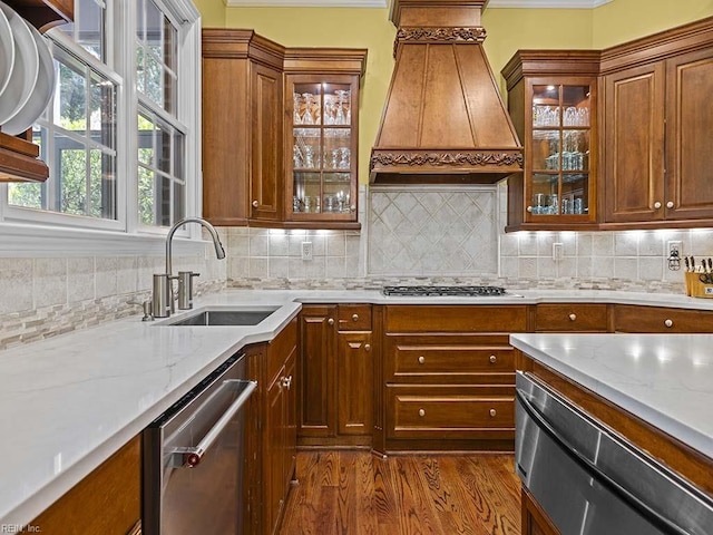 kitchen featuring stainless steel appliances, dark wood-type flooring, sink, tasteful backsplash, and custom exhaust hood