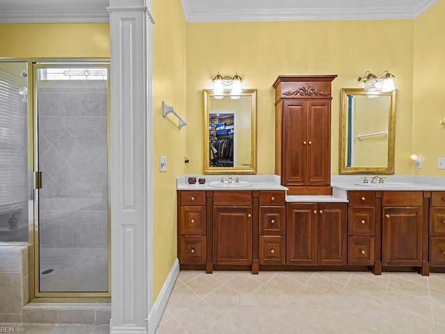 bathroom with decorative columns, an enclosed shower, and ornamental molding