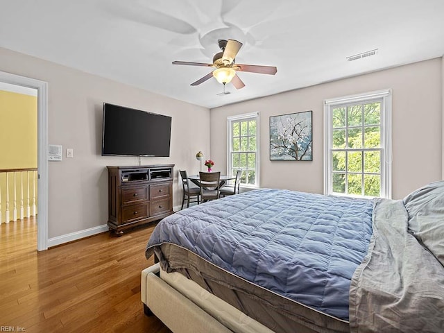 bedroom with hardwood / wood-style floors and ceiling fan