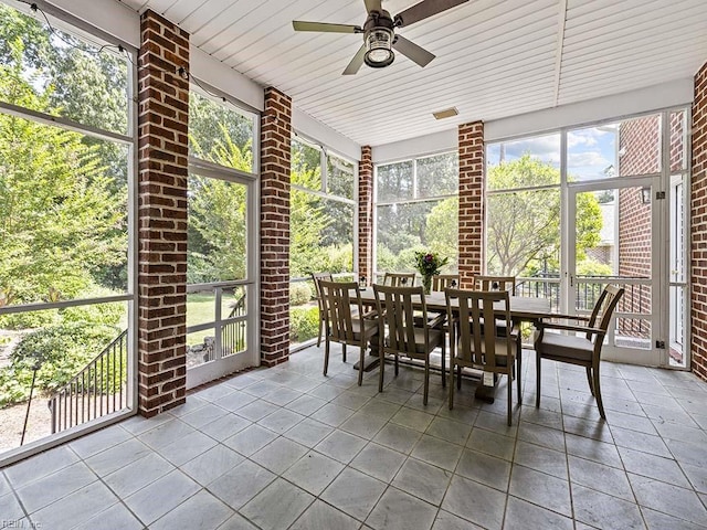 unfurnished sunroom with wood ceiling and ceiling fan