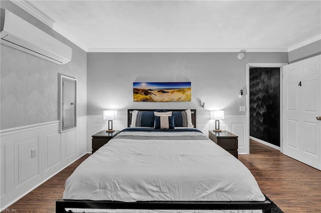 bedroom featuring dark hardwood / wood-style floors, crown molding, and a wall unit AC