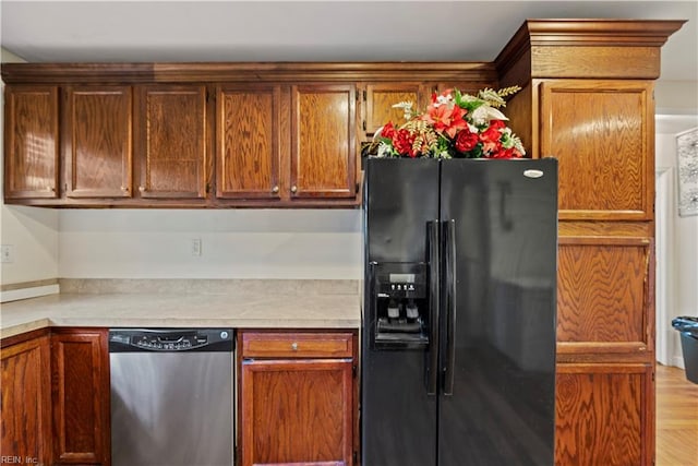 kitchen featuring dishwasher, light wood-type flooring, and black refrigerator with ice dispenser