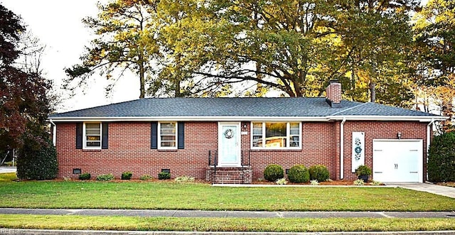 single story home featuring a garage and a front yard