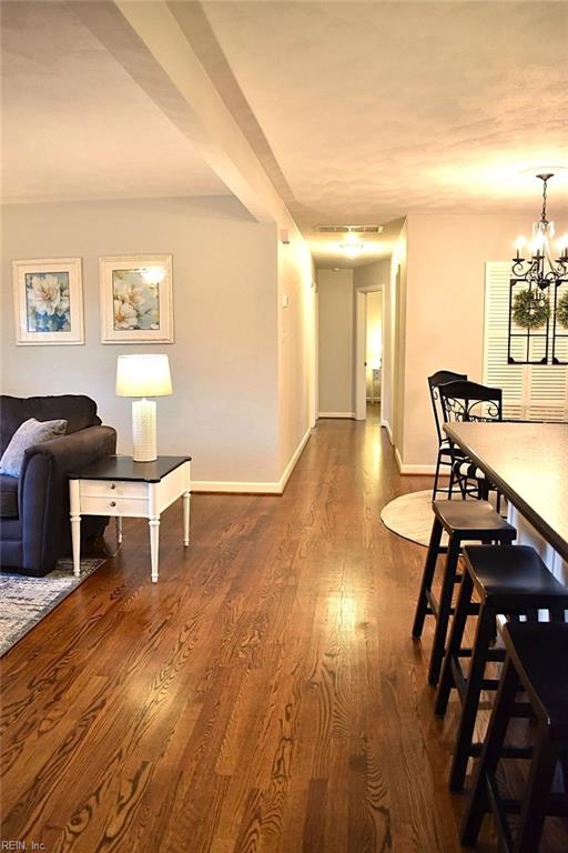 dining space featuring dark hardwood / wood-style floors and a notable chandelier