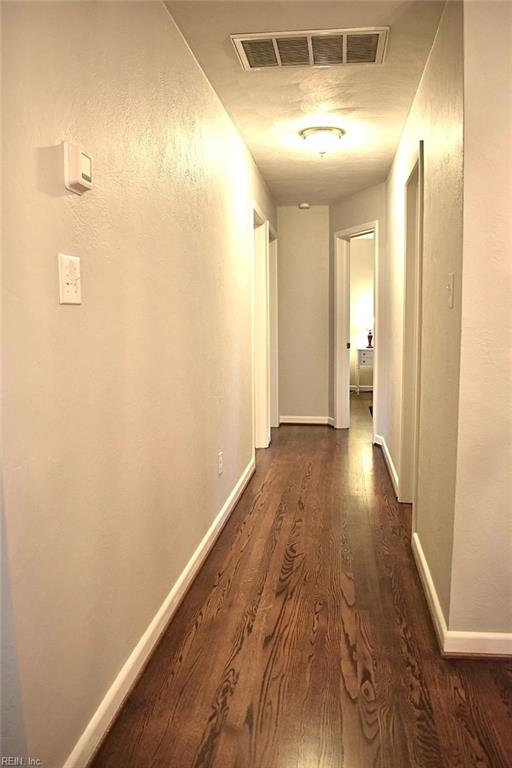 hall with dark hardwood / wood-style flooring