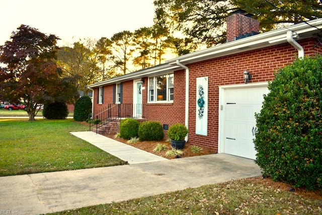 exterior space with a garage and a front lawn