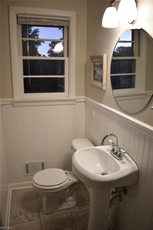 bathroom with a healthy amount of sunlight and toilet