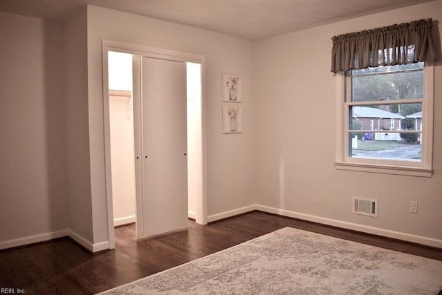 empty room featuring dark wood-type flooring