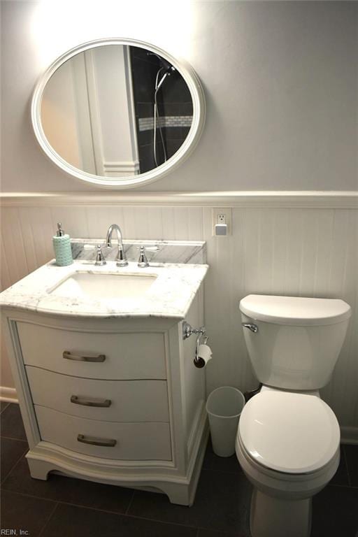 bathroom with tile patterned flooring, vanity, and toilet