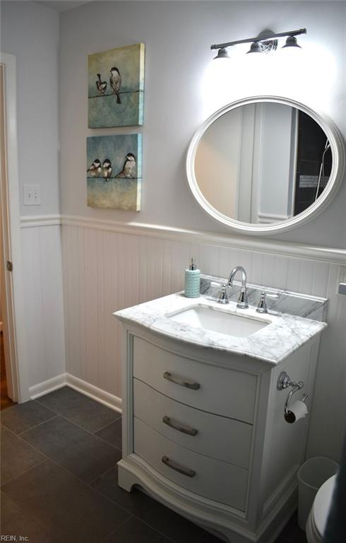 bathroom featuring tile patterned flooring and vanity