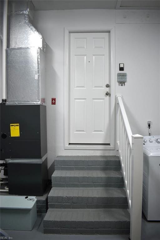 stairway featuring washer / dryer and heating unit