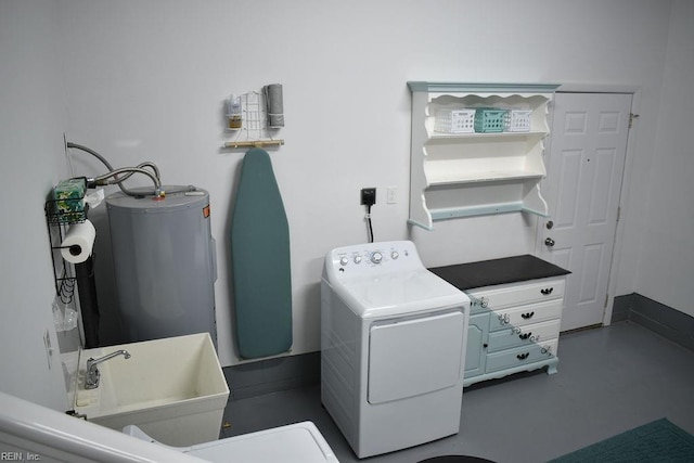 laundry area featuring electric water heater, washer / dryer, and sink