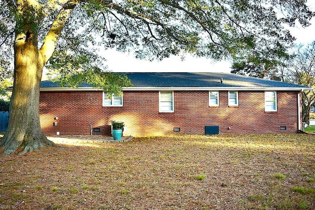 view of side of property with a lawn