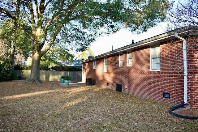 view of side of property with a yard