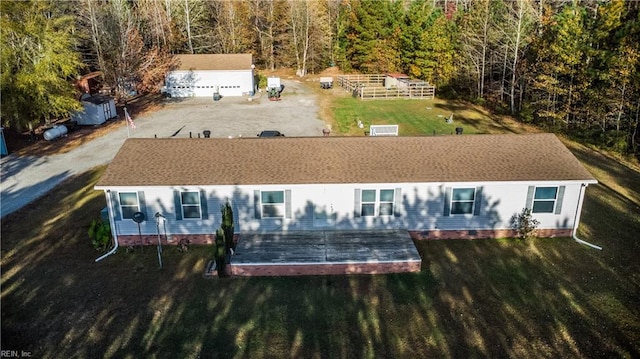 back of house featuring a wooden deck and a yard