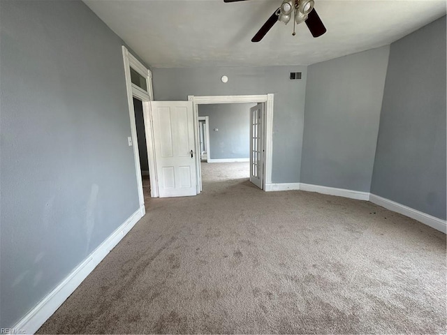 empty room with ceiling fan and light colored carpet