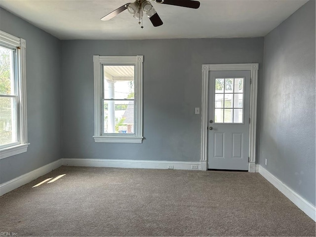 entryway with carpet floors and ceiling fan