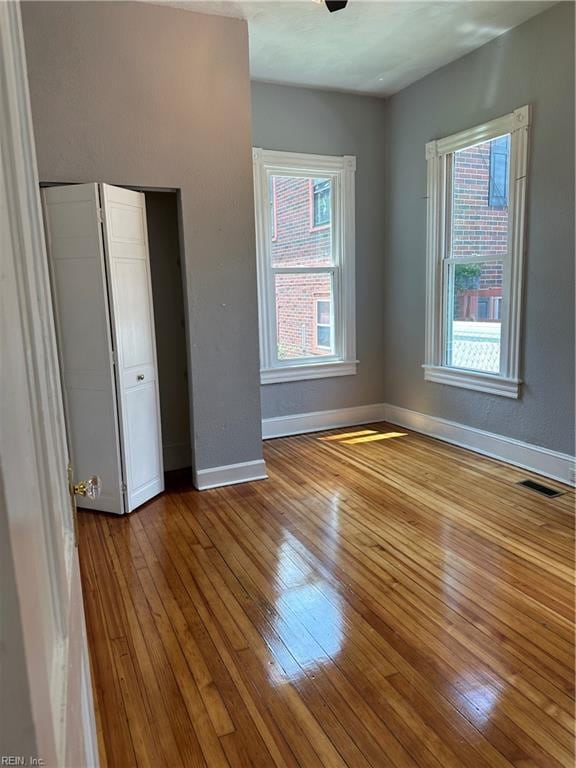 unfurnished bedroom featuring hardwood / wood-style floors and a closet