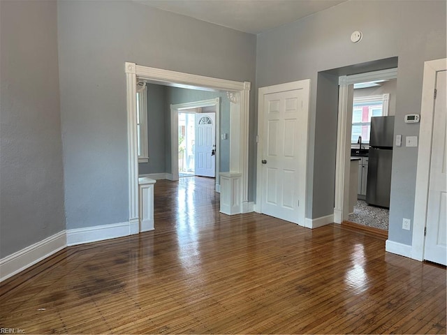 empty room with dark hardwood / wood-style floors and sink