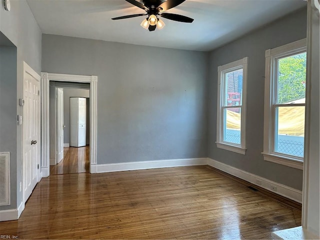 empty room featuring hardwood / wood-style floors and ceiling fan