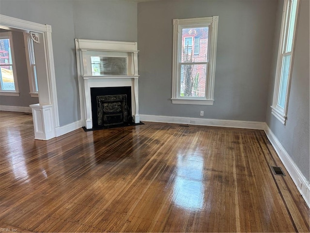 unfurnished living room with dark hardwood / wood-style floors