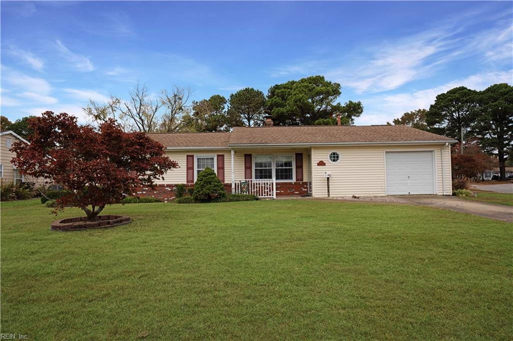 single story home featuring covered porch, a garage, and a front lawn