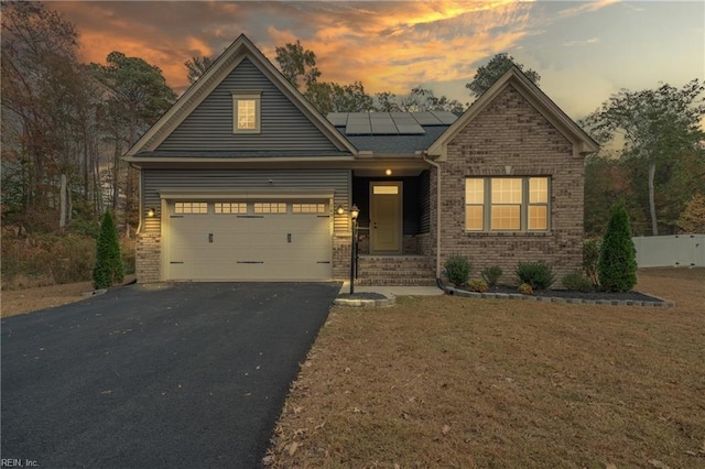 craftsman house with a garage and a lawn