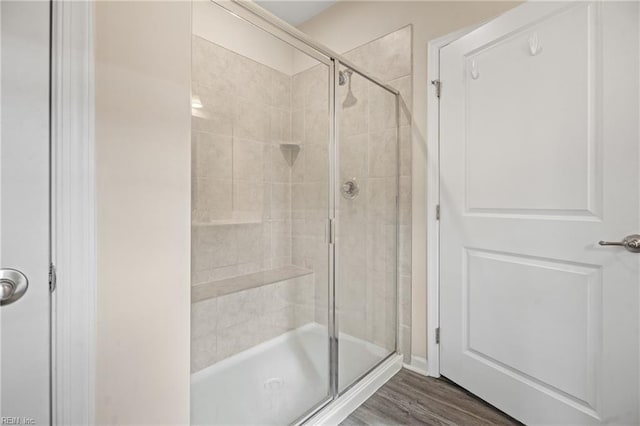 bathroom featuring hardwood / wood-style floors and an enclosed shower