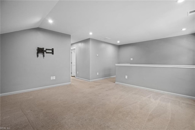 carpeted spare room with lofted ceiling