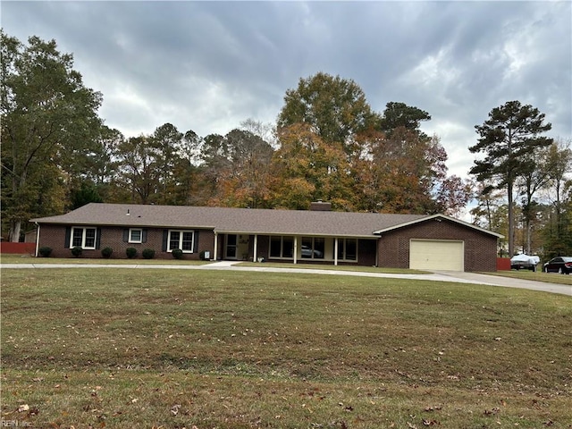 single story home with a front yard and a garage