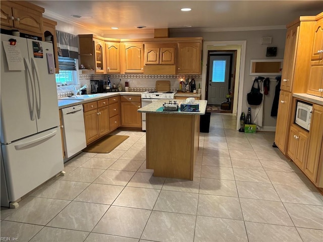 kitchen with a center island, white appliances, crown molding, sink, and decorative backsplash