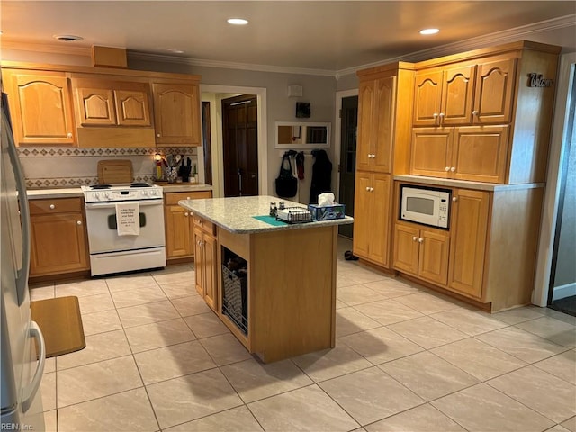 kitchen with light stone counters, white appliances, crown molding, a kitchen island, and light tile patterned flooring