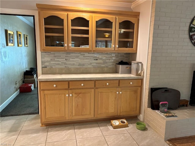 bar featuring ornamental molding and light tile patterned flooring