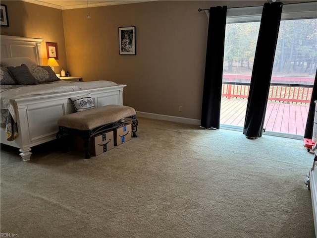 carpeted bedroom featuring access to exterior and ornamental molding