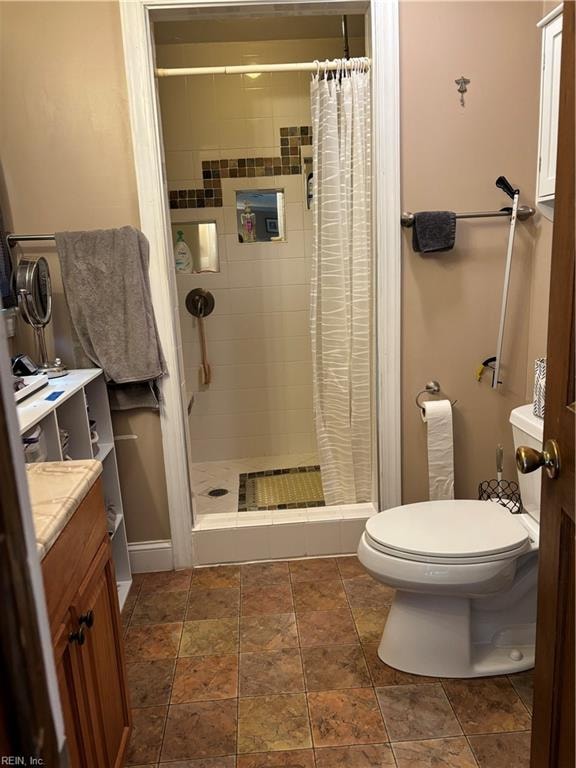 bathroom featuring vanity, toilet, and walk in shower